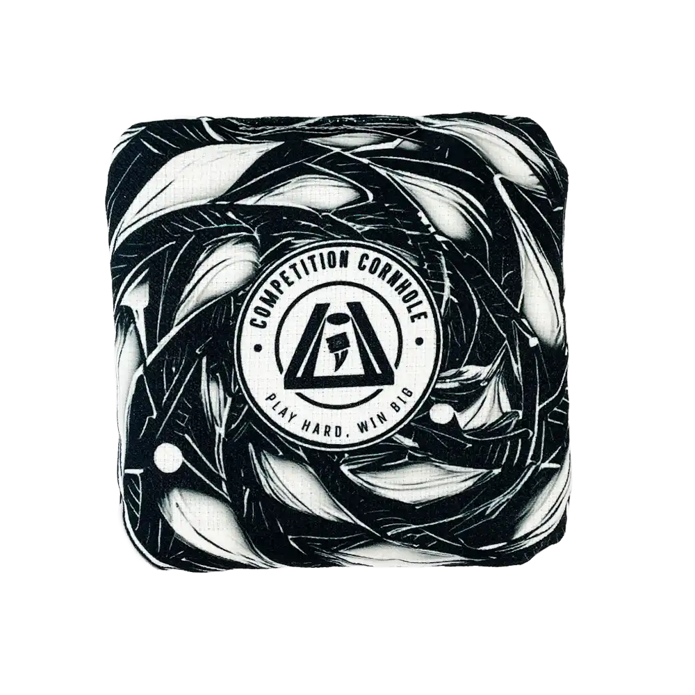 Cornhole bag with black and white abstract design and 'Competition Cornhole' logo on a white background