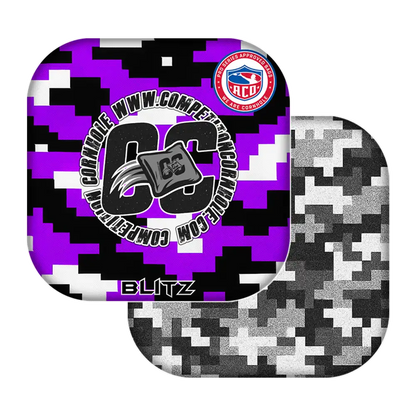 Two camouflage-patterned cornhole bags with visible branding on a white background
