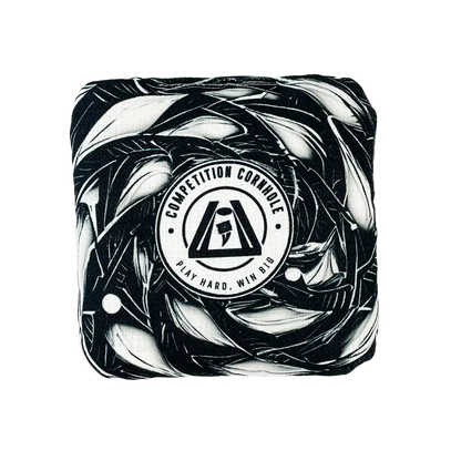 Cornhole bag with black and white abstract design and 'Competition Cornhole' logo on a white background